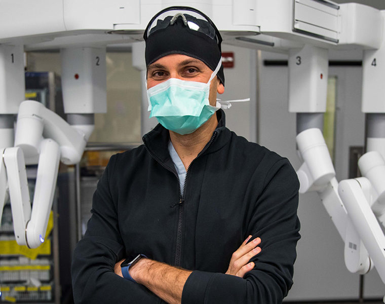 St. Joe's Surgeons Perform Canada’s First Fully Robotic Esophagectomy. A photo of Dr. Waël Hanna in front of the surgical robot used for the procedure.